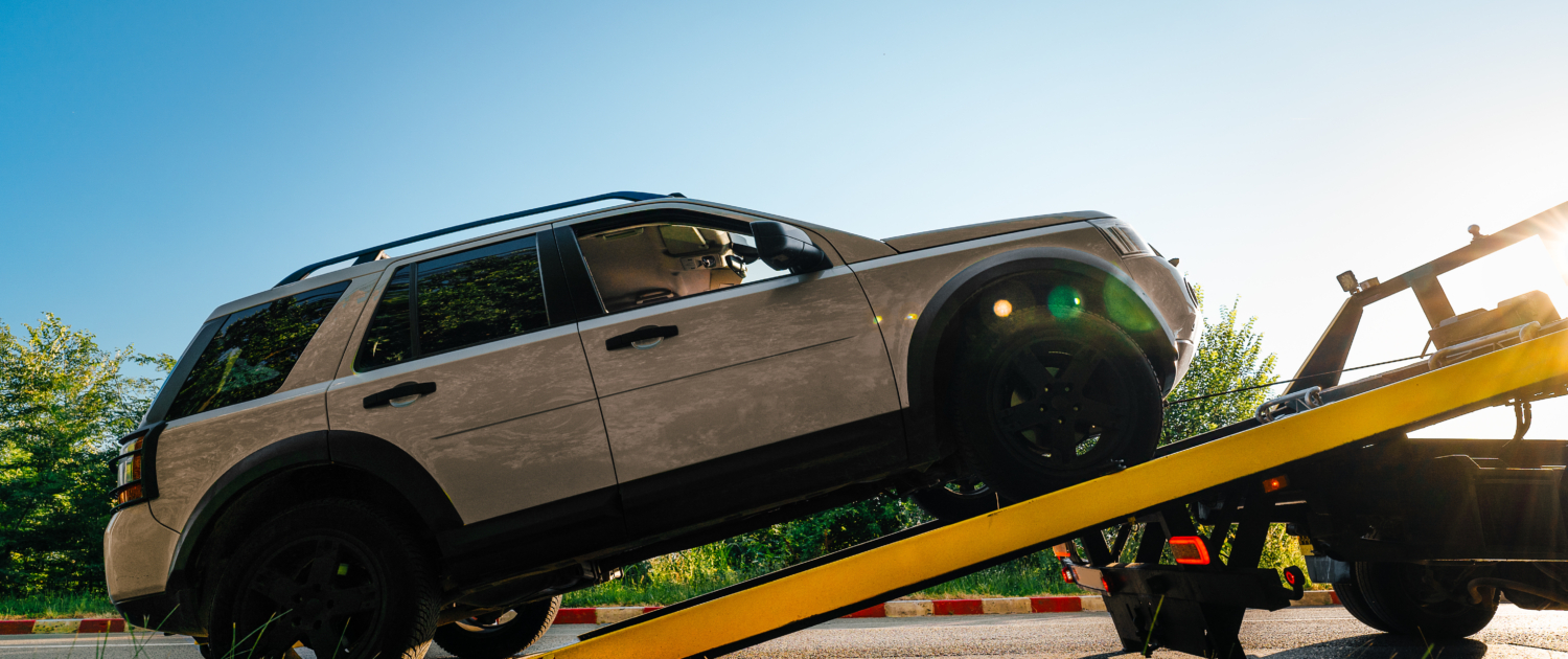 Broken car on tow truck